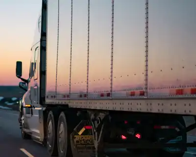 The side of a large metal freight transport truck