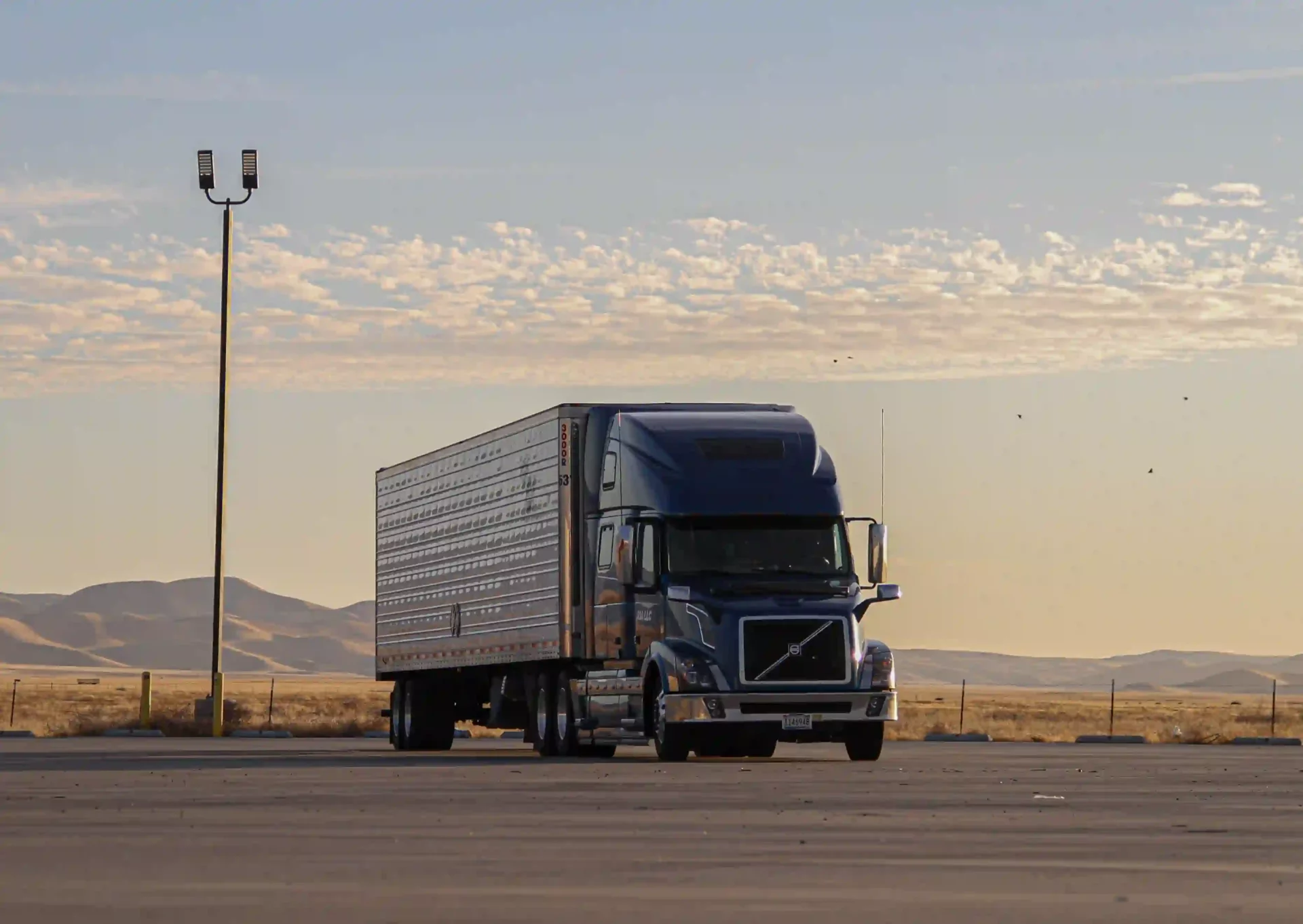 A large cargo truck parked on a cemented area